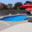 Free form pool with patio umbrella off to the side