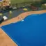 Slight overhead angle of lady opening her pool cover New York